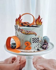 a birthday cake with hot wheels decorations on it