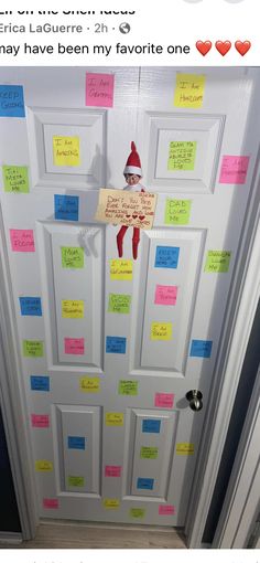 a door decorated with post it notes and an elf's hat