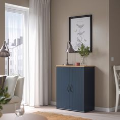 a blue cabinet in the corner of a living room