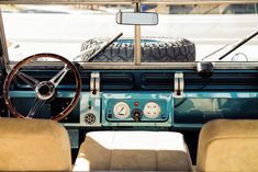 the interior of an old car with steering wheel and gauges on it's dashboard