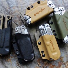 four different types of holsters sitting on top of a rock