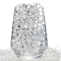 a glass filled with lots of bubbles on top of a table