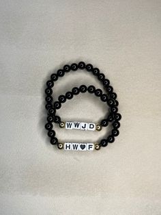 Beautiful handmade bracelets with a meaningful touch: WWJD (What Would Jesus Do) and HWLF (He Would Love First). These elegant pieces feature a stylish black and gold design. Embrace the inspiration and style. #wwjd #hwlf He Would Love First Bracelet, Wwjd Hwlf Bracelet, Hwlf Bracelets, Wwjd Hwlf, He Would Love First, Black And Gold Design, Handmade Beaded Bracelets, What Would Jesus Do, Faith Jewelry