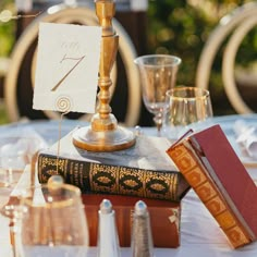 a table topped with books and candles