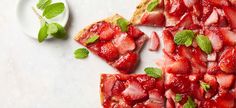 slices of strawberry pizza with mint leaves on top