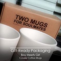 two mugs sitting next to each other in front of a box