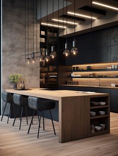 a modern kitchen with wooden floors and black walls, along with pendant lights hanging from the ceiling