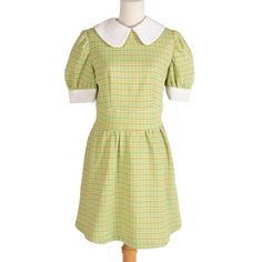 Adorable green mini dress from the 60s with orange grid throughout. Comes with white round collar and sleeve borders. Zipper in back. 100% polyester. Measurements Bust: 34" Waist: 29" Hips: 48" Length: 36" Shoulder-to-Shoulder: 14.5" Sleeve Length: 11.5" Condition: Excellent vintage condition! 60s Collar Dress, Green Collared Mini Dress With Button Closure, Vintage Mini Dress With Doll Collar, Vintage Doll Collar Fitted Dress, Vintage Doll Collar Dress For Dress-up, Green Mini Dress, Collar Dress, Dress Clothes For Women, 1960s