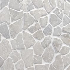 a close up view of a stone wall with white and gray stones on it's surface