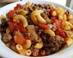 a white bowl filled with pasta and meat