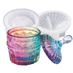 two colorful glass cups with lids and spoons in the shape of an angel's wings