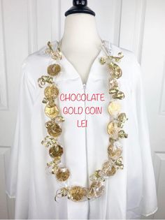 a white shirt with gold coins on it and the words chocolate gold coin lei written in red