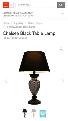 a lamp that is sitting on top of a table with a black lampshade