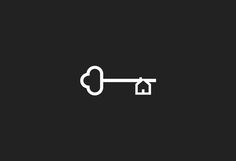 a key with a house on it is shown in the middle of a black background