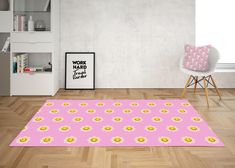 a pink rug with yellow smiley faces on it in front of a white chair and bookshelf