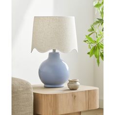 a blue lamp sitting on top of a wooden table