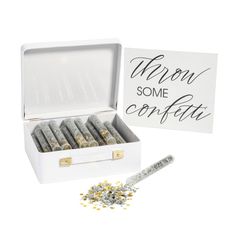 a white box filled with silver confetti next to a sign that says wrong some confetti