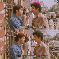 two young men talking to each other in front of a wall with words written on it