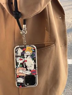 a cell phone case hanging from the side of a person's back pocket with cartoon characters on it