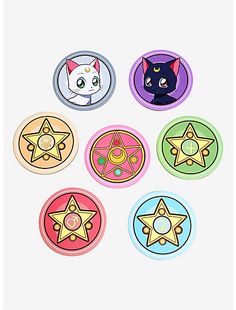 four different colored buttons with cats and stars in the middle one has a cat's face on it