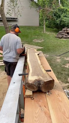 a man is using a chainsaw to cut wood