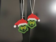 two beaded christmas ornaments hanging from a hook