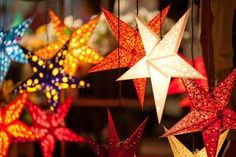 several colorful paper stars hanging from strings