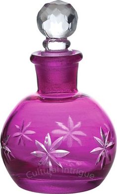 a purple glass bottle with flowers painted on the top and bottom, sitting in front of a white background