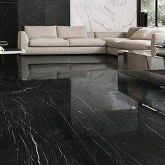 a living room with marble flooring and black walls