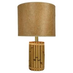 a bamboo lamp with a beige shade on it