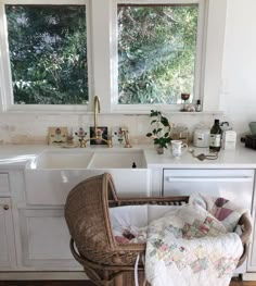 a wicker chair sitting in front of a kitchen sink