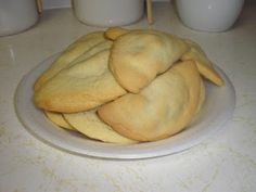 a white plate topped with cookies on top of a counter