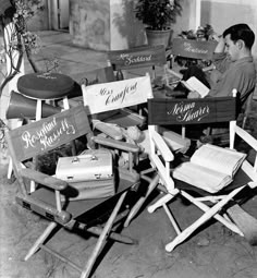 a man sitting in a chair with many signs on it