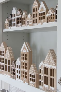 Learn how to make DIY wood gingerbread houses! This adorable Christmas craft is fun for the whole family and is the perfect farmhouse Christmas decor. Modern Christmas Village Houses, Wooden Houses Craft Christmas, Wooden Houses Christmas Decoration, Wooden House Christmas Village, Christmas Diy Wooden Crafts, White Christmas Houses Diy, Diy Craft House, Gingerbread House Wooden Diy, Wooden House Decoration Christmas