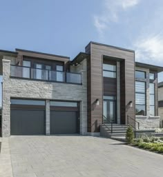 a large house with two garages on the front and second story is shown in this image