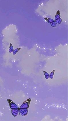 there are many blue butterflies flying in the sky with sparkles and stars on them