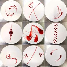 six plates with different designs on them and one has red paint splattered on it