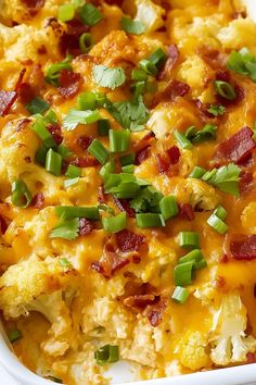 a casserole dish with bacon, cheese and green onions