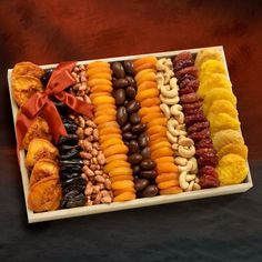 an assortment of dried fruits and nuts in a tray