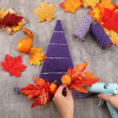 someone is decorating an autumn tree with leaves