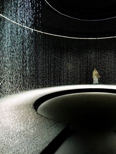 a woman is standing in the rain room