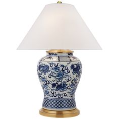 a blue and white vase lamp with a white shade on the top, sitting against a white background