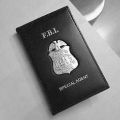 a black and white photo of a special agent's passport on top of a table