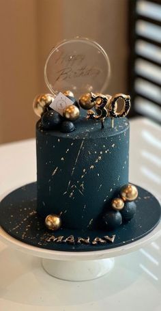 a blue cake with gold decorations on it