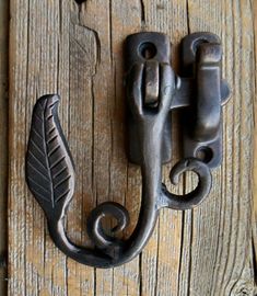 an old door handle with a leaf on it