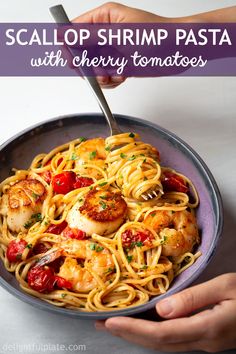 a plate of pasta with shrimp and cherry tomatoes on it, next to a fork