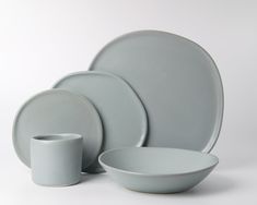 a set of gray dishes and cups on a white background