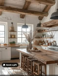 a kitchen with white cabinets and wooden counter tops, an island in the middle is surrounded by stools