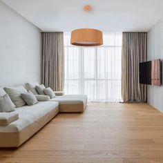 a living room filled with furniture and a flat screen tv mounted to the side of a wall