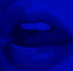 a close up view of a blue lip with the words nobody does it make you do